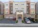 The exterior of the apartment buildings includes brick accents and attached garages at 7565 Laureate Blvd # 3408, Orlando, FL 32827