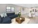 Relaxing living room seamlessly transitions to dining area and a modern kitchen, ideal for entertaining at 7565 Laureate Blvd # 3408, Orlando, FL 32827