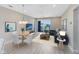 Bright living room features comfortable seating, a ceiling fan, access to a balcony, and luxury vinyl floors at 7565 Laureate Blvd # 3408, Orlando, FL 32827