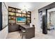 The resident meeting room has a large table with shelving for storage, creating a functional and stylish space at 7565 Laureate Blvd # 3408, Orlando, FL 32827