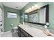Bathroom featuring a granite countertop, an updated vanity, and large mirror at 819 E Harbour Ct, Ocoee, FL 34761