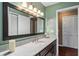 Bathroom featuring a granite countertop, updated vanity, and large mirror and natural lighting at 819 E Harbour Ct, Ocoee, FL 34761