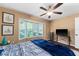 Bedroom featuring bay window, ceiling fan, hardwood flooring and television at 819 E Harbour Ct, Ocoee, FL 34761