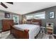 Comfortable bedroom showcasing a wooden bed frame and bright natural light at 819 E Harbour Ct, Ocoee, FL 34761