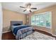 Cozy bedroom with large bay window, ceiling fan, and hardwood flooring at 819 E Harbour Ct, Ocoee, FL 34761