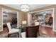 Dining room with a glass table, hardwood floors, and views into the living room at 819 E Harbour Ct, Ocoee, FL 34761