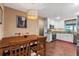 Dining area and kitchen with granite counters, modern appliances, and wood flooring at 819 E Harbour Ct, Ocoee, FL 34761