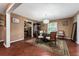 Dining room with hardwood floors, a glass table, and views into a living room space at 819 E Harbour Ct, Ocoee, FL 34761