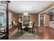 Dining room with hardwood floors, a glass table, a modern chandelier, and natural lighting at 819 E Harbour Ct, Ocoee, FL 34761