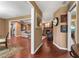Home foyer featuring hardwood floors that transition into a living room with a brick fireplace at 819 E Harbour Ct, Ocoee, FL 34761