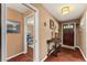 Foyer with hardwood floors, a decorative table, and a view into the living area and bedroom at 819 E Harbour Ct, Ocoee, FL 34761