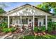 Inviting front porch with mature landscaping, rocking chairs and a white painted brick exterior at 819 E Harbour Ct, Ocoee, FL 34761