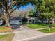 Well maintained single-story home with lush landscaping, a driveway, and charming curb appeal at 819 E Harbour Ct, Ocoee, FL 34761