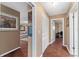 Hallway with hardwood floors, decor, storage and entrances to the living room and office at 819 E Harbour Ct, Ocoee, FL 34761