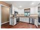 Charming kitchen with white cabinets, granite countertops, stainless steel appliances, and wood floors at 819 E Harbour Ct, Ocoee, FL 34761