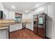 Bright kitchen features white cabinets, granite counters, stainless appliances, and wood floors at 819 E Harbour Ct, Ocoee, FL 34761