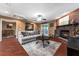 Comfortable living room showcases a brick fireplace, wood floors, and French doors at 819 E Harbour Ct, Ocoee, FL 34761