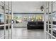 Bright sunroom with large windows, tile floors, and dark leather sofa at 819 E Harbour Ct, Ocoee, FL 34761
