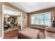 Sitting room showcasing wood floors, bay window, and seamless dining room access at 819 E Harbour Ct, Ocoee, FL 34761