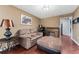 Sitting room featuring wood floors, comfortable furniture, and vintage desk at 819 E Harbour Ct, Ocoee, FL 34761