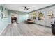 Bright sunroom with large windows, tile floors, and a small brown sofa at 819 E Harbour Ct, Ocoee, FL 34761