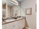 A modern bathroom with double sinks, granite countertops, a large mirror, and ample lighting at 8383 Madrid St, Lakeland, FL 33810