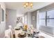 Stylish dining area with a white table, neutral decor, and large windows offering plenty of natural light at 8383 Madrid St, Lakeland, FL 33810