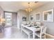Bright dining area featuring a white table with bench seating, modern lighting, and neutral-toned walls at 8383 Madrid St, Lakeland, FL 33810