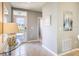 Inviting entryway with a glass-topped console table, neutral-toned walls, and a view of the front door at 8383 Madrid St, Lakeland, FL 33810