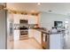 Contemporary kitchen featuring stainless steel appliances, white cabinets, and granite countertops at 8383 Madrid St, Lakeland, FL 33810