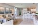 This living room features neutral decor, large windows, and an open layout flowing into the kitchen at 8383 Madrid St, Lakeland, FL 33810