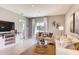 Cozy living room with modern furnishings, neutral decor, large windows and seamless flow to adjacent rooms at 8383 Madrid St, Lakeland, FL 33810