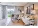 Cozy living room featuring neutral tones, stylish decor, and a bright window with a picturesque backyard view at 8383 Madrid St, Lakeland, FL 33810