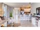 An open-concept living room flows to a kitchen and dining area with neutral decor and lots of natural light at 8383 Madrid St, Lakeland, FL 33810