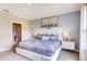 A bright, well-lit main bedroom featuring a plush bed, stylish decor, and an en-suite bathroom at 8383 Madrid St, Lakeland, FL 33810