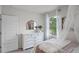 Bright bedroom boasts a white dresser, and large window overlooking the lake at 8391 Madrid St, Lakeland, FL 33810