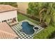 Aerial view showcasing the beautiful pool, spa, outdoor kitchen, and manicured backyard at 9032 Tavolini Ter, Windermere, FL 34786