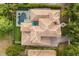 Aerial view of a stunning home featuring a pool, spa, and backyard, surrounded by lush landscaping at 9032 Tavolini Ter, Windermere, FL 34786