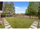 Spacious backyard with lush green artificial turf and stone pavers leading to a soccer net at 9032 Tavolini Ter, Windermere, FL 34786