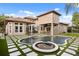Stunning backyard featuring a large pool, spa, patio, and artificial turf at 9032 Tavolini Ter, Windermere, FL 34786