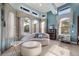 A tranquil bedroom features large windows and natural light with comfortable sitting area at 9032 Tavolini Ter, Windermere, FL 34786
