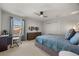 Cozy bedroom featuring a comfortable bed, desk, and ample natural light at 9032 Tavolini Ter, Windermere, FL 34786