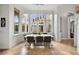 Bright dining room with large windows, tile floors, and modern chandelier at 9032 Tavolini Ter, Windermere, FL 34786