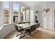 Elegant dining room featuring large windows, marble-topped table, and views of the backyard at 9032 Tavolini Ter, Windermere, FL 34786