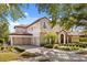 Stately home showcases a three-car garage and manicured landscaping, creating a welcoming curb appeal at 9032 Tavolini Ter, Windermere, FL 34786
