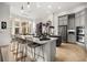 Spacious kitchen with a large island, seating, stainless steel appliances and neutral color palette at 9032 Tavolini Ter, Windermere, FL 34786