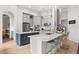 Bright kitchen with white cabinets, marble countertops, stainless steel appliances, and a center island at 9032 Tavolini Ter, Windermere, FL 34786
