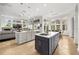 Bright, open kitchen features a large island, modern appliances, and seamless flow into dining and living spaces at 9032 Tavolini Ter, Windermere, FL 34786