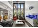 Bright, modern living room features soaring ceilings, an entertainment area and sleek, contemporary furnishings at 9032 Tavolini Ter, Windermere, FL 34786