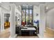 Grand living room with soaring ceilings, elegant columns, and a stunning aquarium as focal point at 9032 Tavolini Ter, Windermere, FL 34786